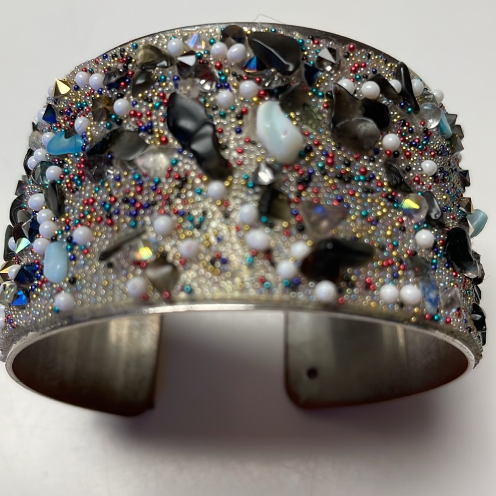 Hand bracelet with colorful stones.